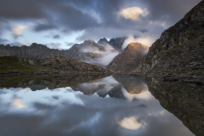 Reflection of Mount Viso hidden in the cloud